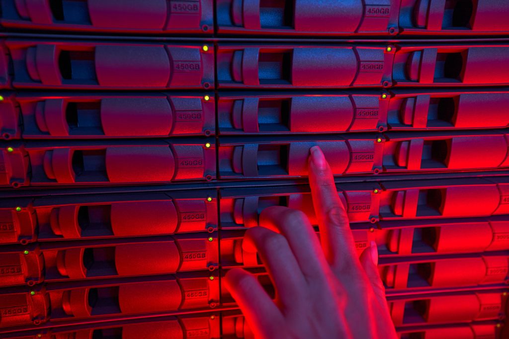 Female system administrator maintain servers in data center