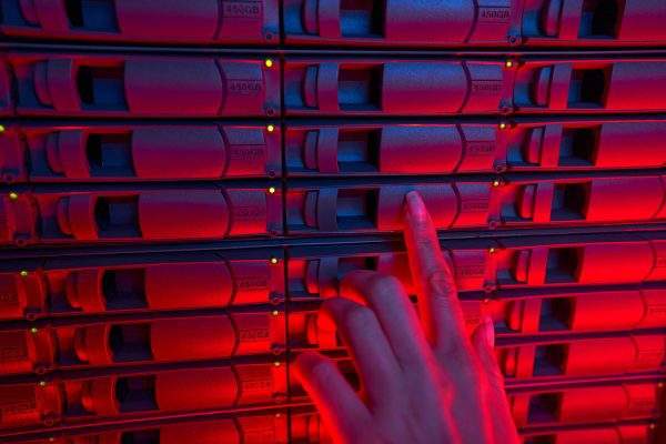 Female system administrator maintain servers in data center